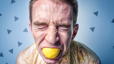 Middle stress of an adult man with a lemon