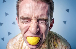 Small stress of an adult man with a lemon