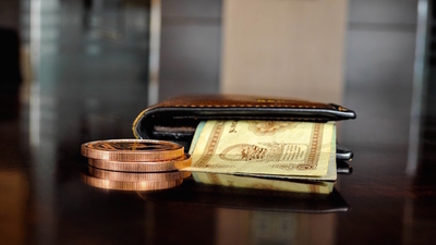 Middle bronze coins and cash in a wallet