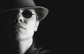Small person sunglasses dark hat 1